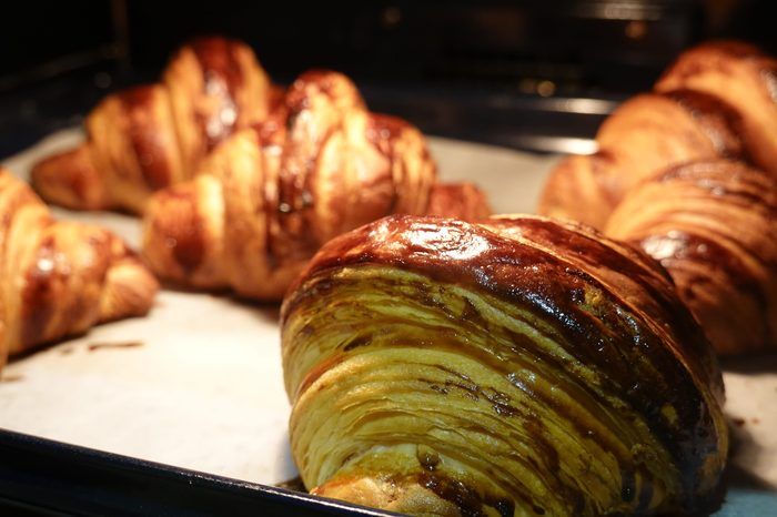 Freshly baked golden croissants close up