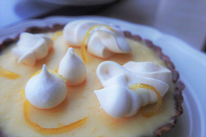 Lemon tart with meringue kisses, close up